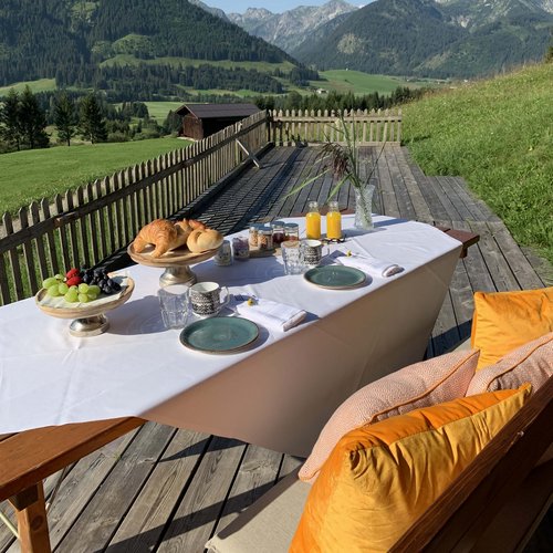 Hotel Sonnenhof Breakfast table with croissants and juice on terrace in the mountains