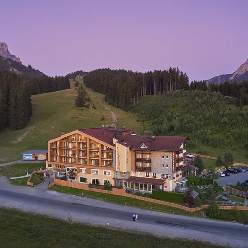 Hotel Sonnenhof Sonnenhof hotel in front of forest and mountains at dusk