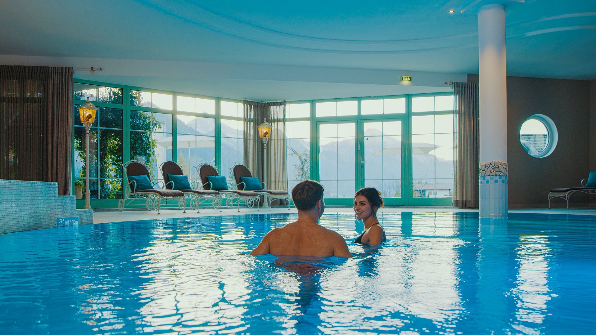 Hotel Sonnenhof Couple relaxing in indoor pool with mountain view