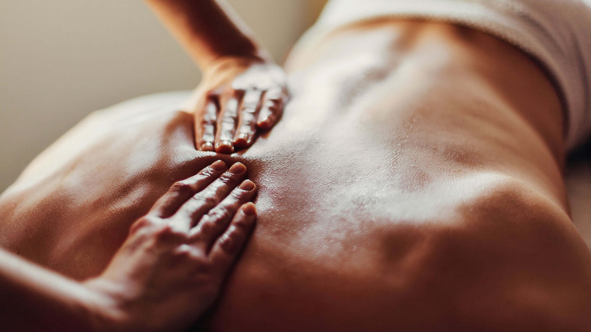 Hotel Sonnenhof Person receiving an oil massage on the back in a relaxed setting