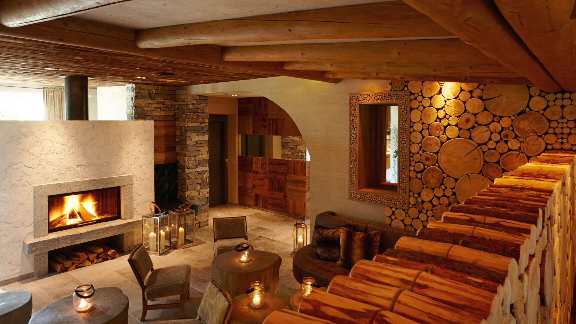 Hotel Sonnenhof Cozy living area with fireplace, logs on wall and ceiling, seating, and candles