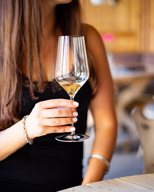 Hotel Sonnenhof Woman holding a glass of white wine in a restaurant